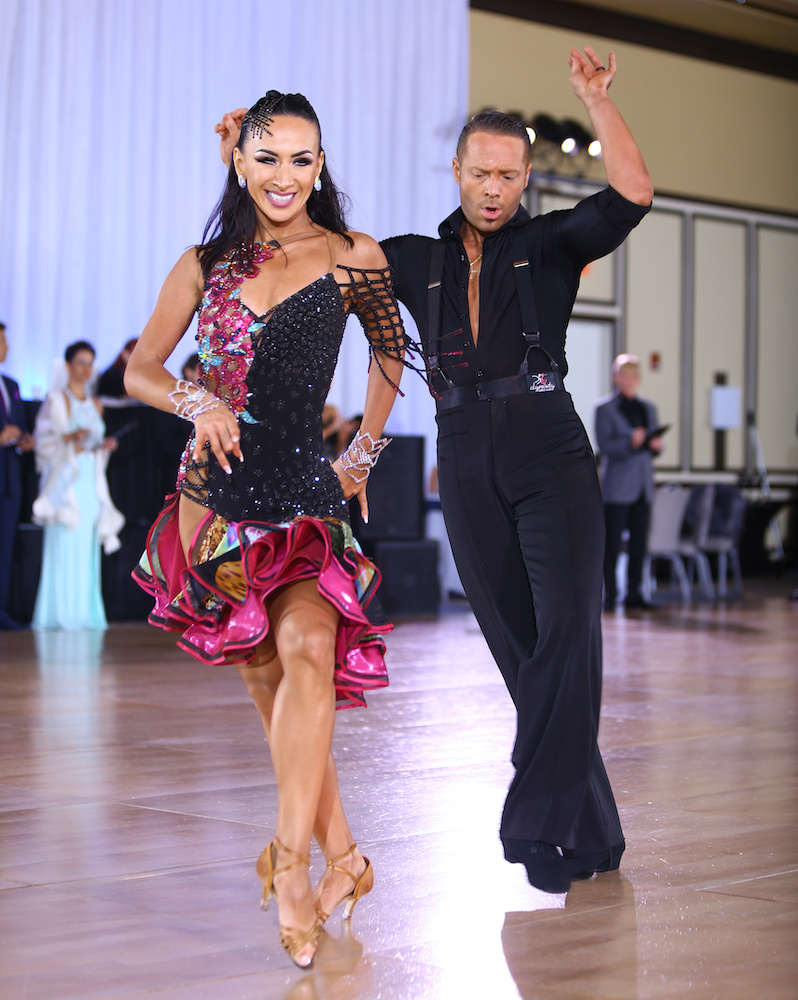 Latin couple mid-routine on the competition floor